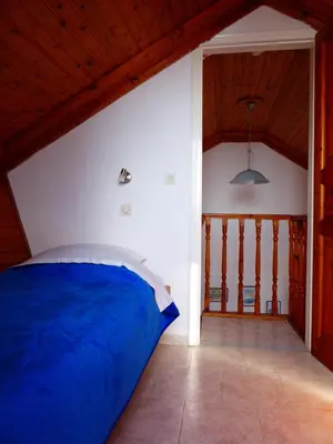 a bedroom with a blue bed in a room at Villa Yorgos in Halki