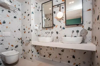 a bathroom with two sinks and a mirror at Mazoren Art Hotel in Faliraki