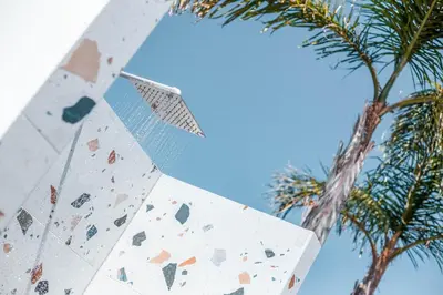 a board with a climbing wall next to a palm tree at Mazoren Art Hotel in Faliraki