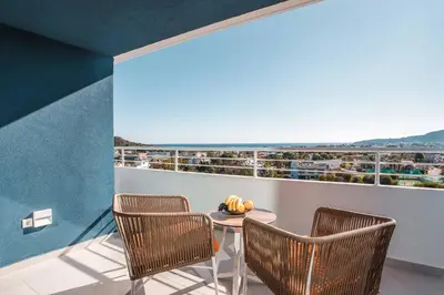 a table and chairs on a balcony with a view at Mazoren Art Hotel in Faliraki