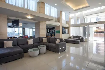 a large living room with couches in a building at Hotel Riviera in Rhodes Town
