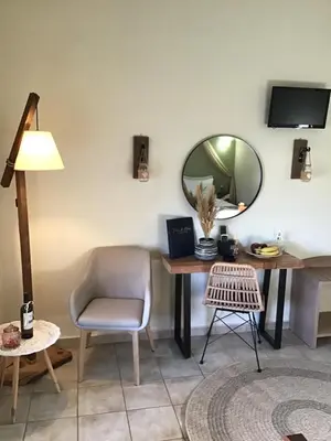 a room with a desk and a chair and a mirror at Fiore di Flora in Archangelos