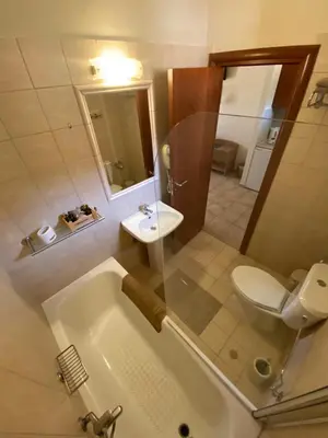 a bathroom with a tub and a toilet and a sink at Fiore di Flora in Archangelos