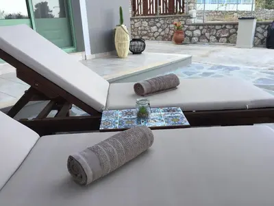 a table with two rolled up pillows on it at Fiore di Flora in Archangelos