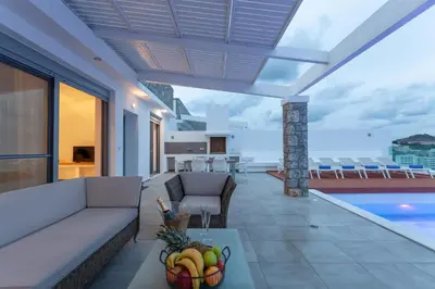 a living room with a couch and a table at Luxury Sunrise White Villa in Líndos