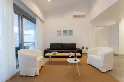 a living room with a couch and two chairs at Luxury Sunrise White Villa in Líndos
