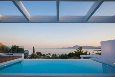 a swimming pool with a view of the water at Luxury Sunrise White Villa in Líndos
