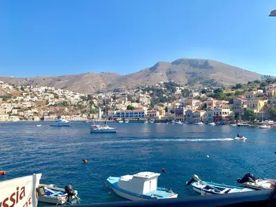 a group of boats in a body of water at Odyssia in Symi