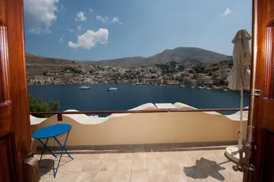 a view from a balcony with a view of the water at Odyssia in Symi