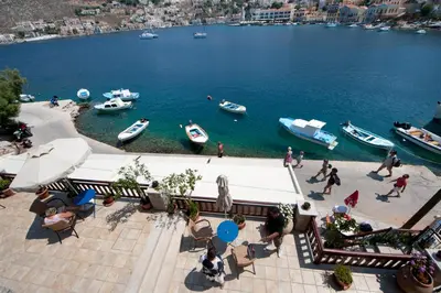 a group of boats in a body of water at Odyssia in Symi