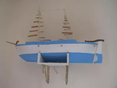a model of a boat hanging on a wall at Chryssa Rooms in Symi