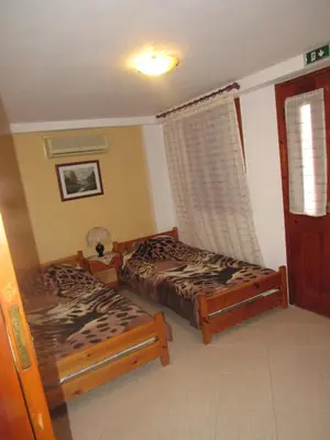 a bedroom with two beds and a window at Chryssa Rooms in Symi