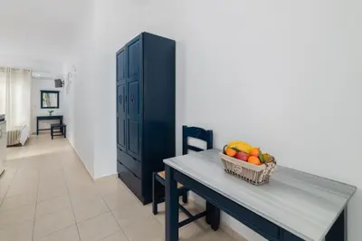 a table with a basket of fruit in a room at Kozas Superior Apartments in Archangelos