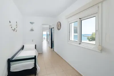 a bedroom with a bed and a window at Kozas Superior Apartments in Archangelos