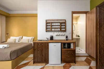 a small room with a bed and a microwave at The Old Symi in Symi