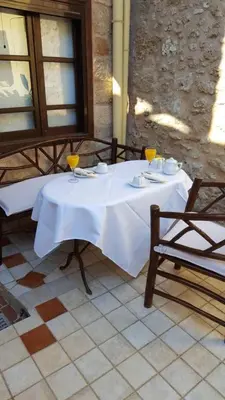 a white table with two chairs and drinks on it at Petrino in Rhodes Town