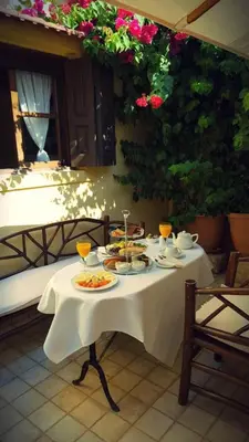 a table with plates of food and drinks on it at Petrino in Rhodes Town