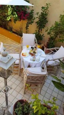 a table and chairs with food and drinks on it at Petrino in Rhodes Town