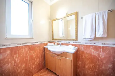 a bathroom with a sink and a mirror at Mediterranean Luxury Villa in Ialyssos