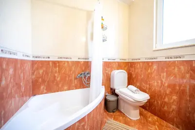 a bathroom with a toilet and a bath tub at Mediterranean Luxury Villa in Ialyssos