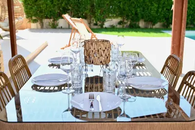 a table with plates and wine glasses on it at Mediterranean Luxury Villa in Ialyssos