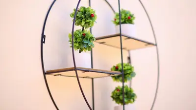 a hanging plant rack with four plants in a mirror at Mediterranean Luxury Villa in Ialyssos
