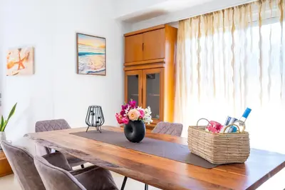 a dining room table with a vase of flowers on it at Mediterranean Luxury Villa in Ialyssos