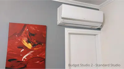 a picture of a painting and a printer on a wall at Budget Studios Haraki in Haraki