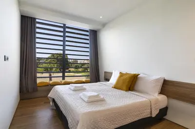 a bedroom with a bed and a large window at Momentum Villas in Ialyssos