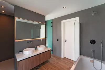 a bathroom with two sinks and a bath tub at Momentum Villas in Ialyssos