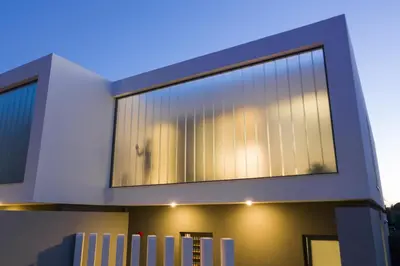 a house with a large window on the side of it at Momentum Villas in Ialyssos