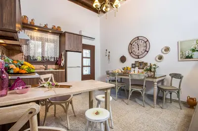 a kitchen and dining room with a table and chairs at La casa di Anna in Rhodes Town