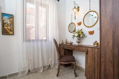 a room with a desk with a mirror and a chair at La casa di Anna in Rhodes Town