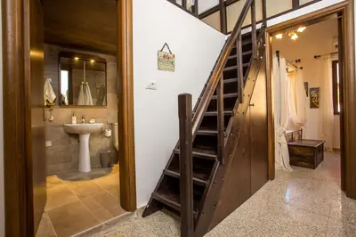 a bathroom with a staircase next to a sink at La casa di Anna in Rhodes Town