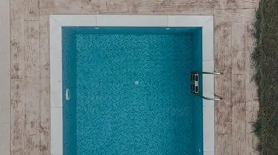 a door to a swimming pool with blue water at Villa Stamatina in Pastida