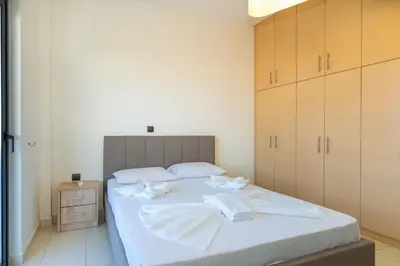 a bedroom with a bed with white towels on it at Villa Stamatina in Pastida