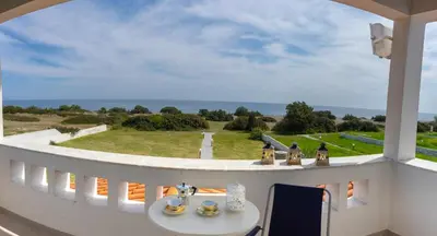 a view from a balcony with a table and chairs at Alkion Villa in Gennadi
