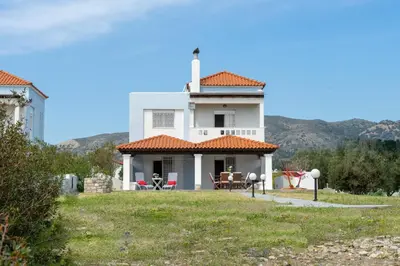 a white house with a red roof at Alkion Villa in Gennadi