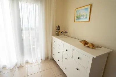 a white dresser in a room with a window at Alkion Villa in Gennadi