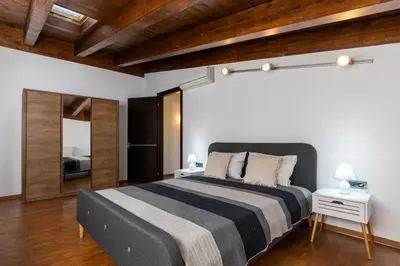 a bedroom with a large bed and a mirror at La Luna Villa in Rhodes Town