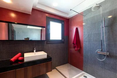a bathroom with a sink and a shower at La Luna Villa in Rhodes Town