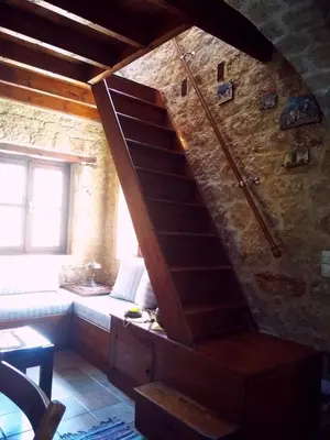 a wooden staircase in a room with a window at Rosalia Apartments in Halki