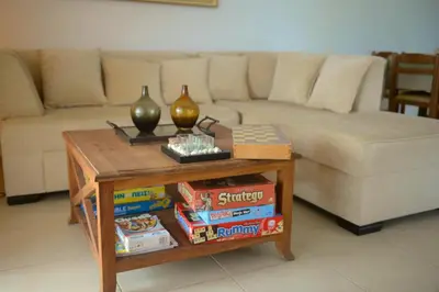 a living room with a couch and a table with books at Blue Harmony Villas in Kiotari
