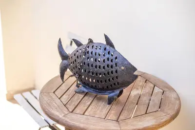 a statue of a fish on a wooden table at Apartment Ivy Kallithea in Rhodes Town