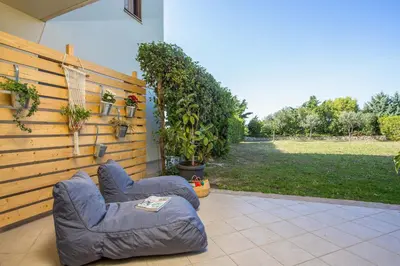 a large inflatable chair sitting on a patio at Apartment Ivy Kallithea in Rhodes Town