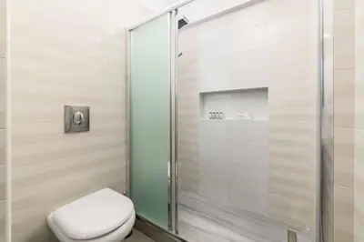 a shower stall with a toilet in a bathroom at Villa Summer Light in Kiotari