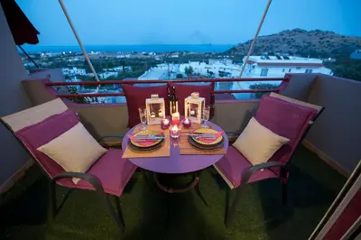 a table and chairs on a balcony with a view at Lila Studio in Kalathos
