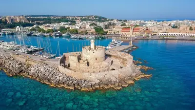 an island with a castle in the middle of the water at Lila Studio in Kalathos