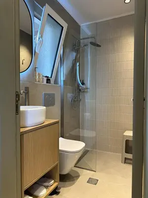 a bathroom with a toilet and a sink and a shower at Stegna Sea & Sun in Archangelos