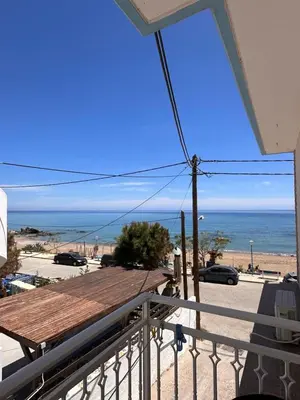 a view of the beach from the balcony of a house at Stegna Sea & Sun in Archangelos